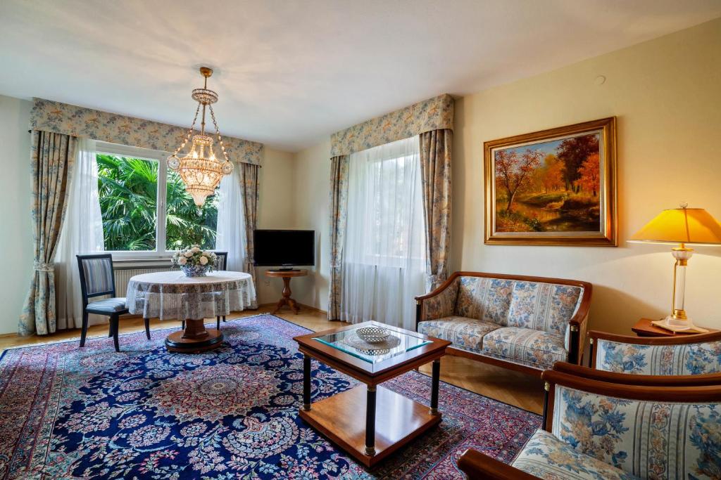 a living room with a couch and a table at Villa Coris Ferienwohnung Magnolia in Merano