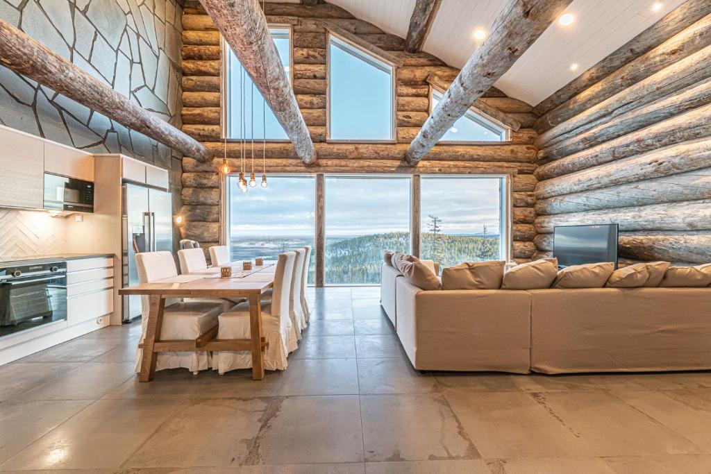 a kitchen and dining room with a couch and a table at Fort Aurora in Levi