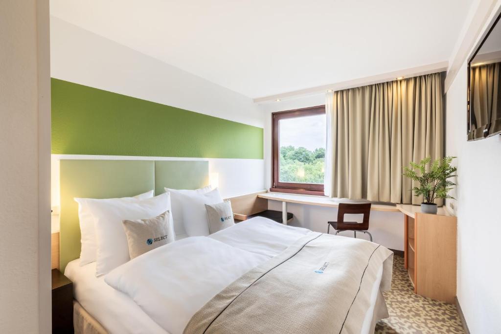 Кровать или кровати в номере Select Hotel Osnabrück