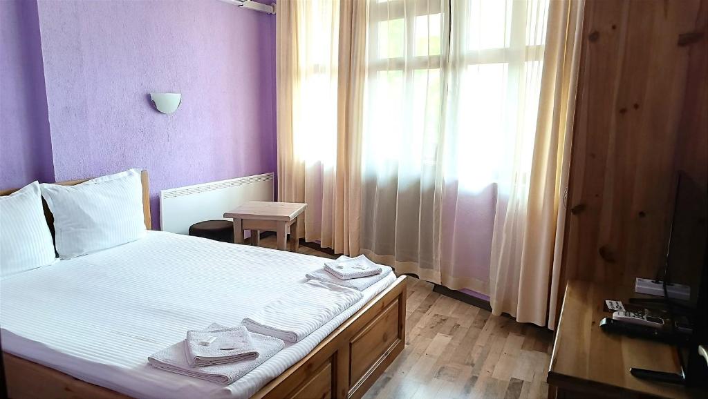 Postel nebo postele na pokoji v ubytování Guesthouse White Margarit