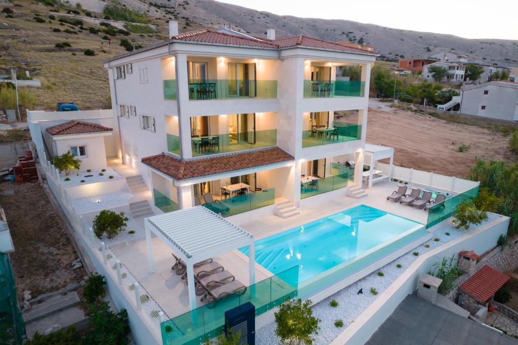 an aerial view of a villa with a swimming pool at Apartvilla Pag in Pag