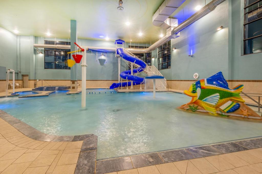 a swimming pool with a water slide in a building at Holiday Inn Express Hotel & Suites Erie an IHG Hotel in North East