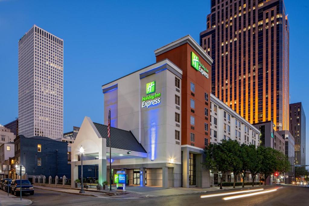 a building with a sign on it in a city at Holiday Inn Express New Orleans Downtown, an IHG Hotel in New Orleans