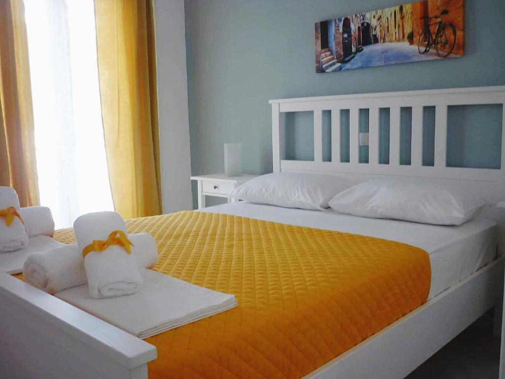 a bedroom with two beds with towels on them at Center of Parga-John's House in Parga
