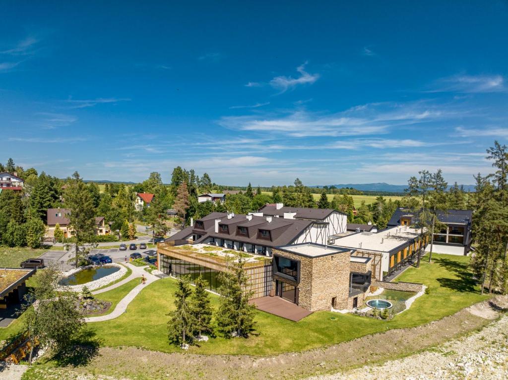 an aerial view of a large house with a yard at Hotel Hills in Stará Lesná