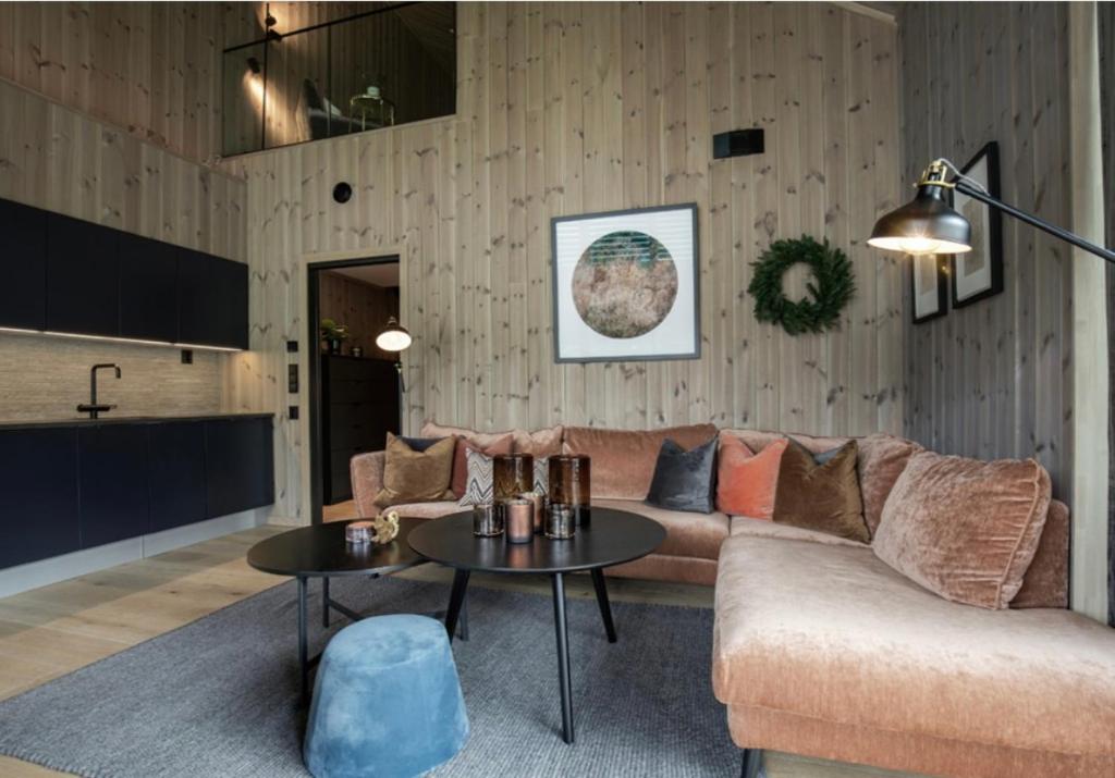 a living room with a couch and a table at Fantastic apartment in Hemsedal, ski in ski out, Fyri Tunet in Hemsedal