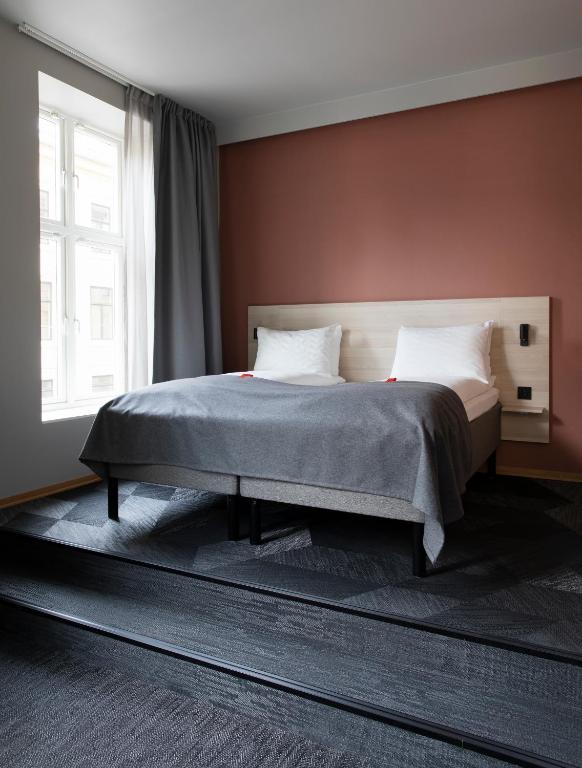 a bedroom with a bed and a large window at Citybox Oslo in Oslo