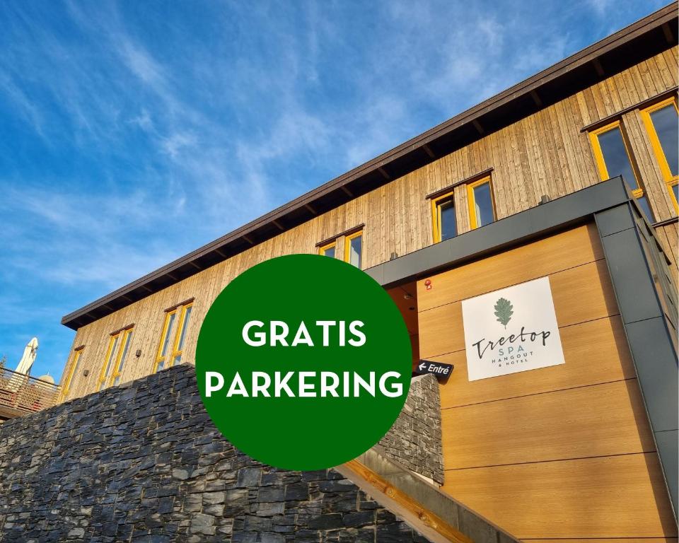 a building with a wooden door with the words crafts parking at Treetop Spa Hangout & Hotel in Gothenburg