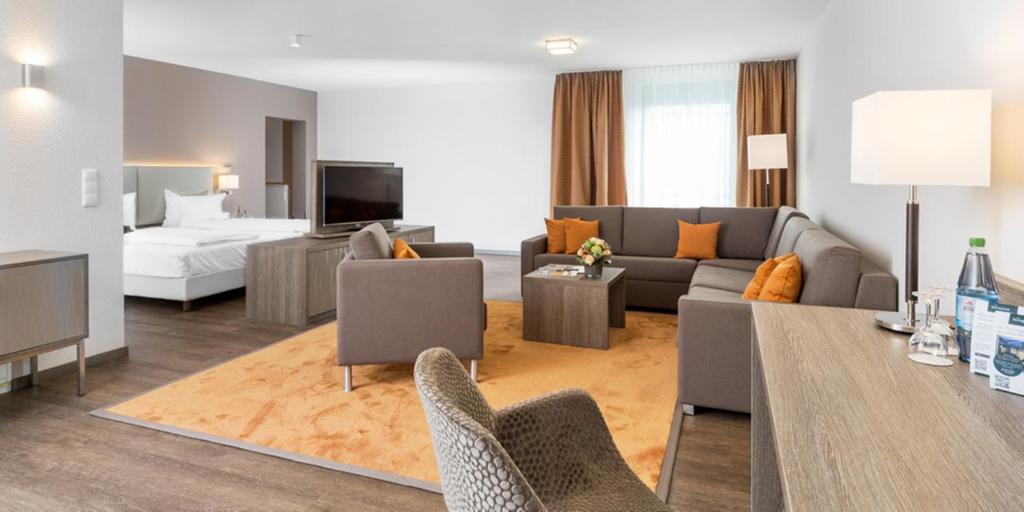 a living room with a couch and a bed at HerzogsPark Apartments mit oder ohne Küche in Herzogenaurach