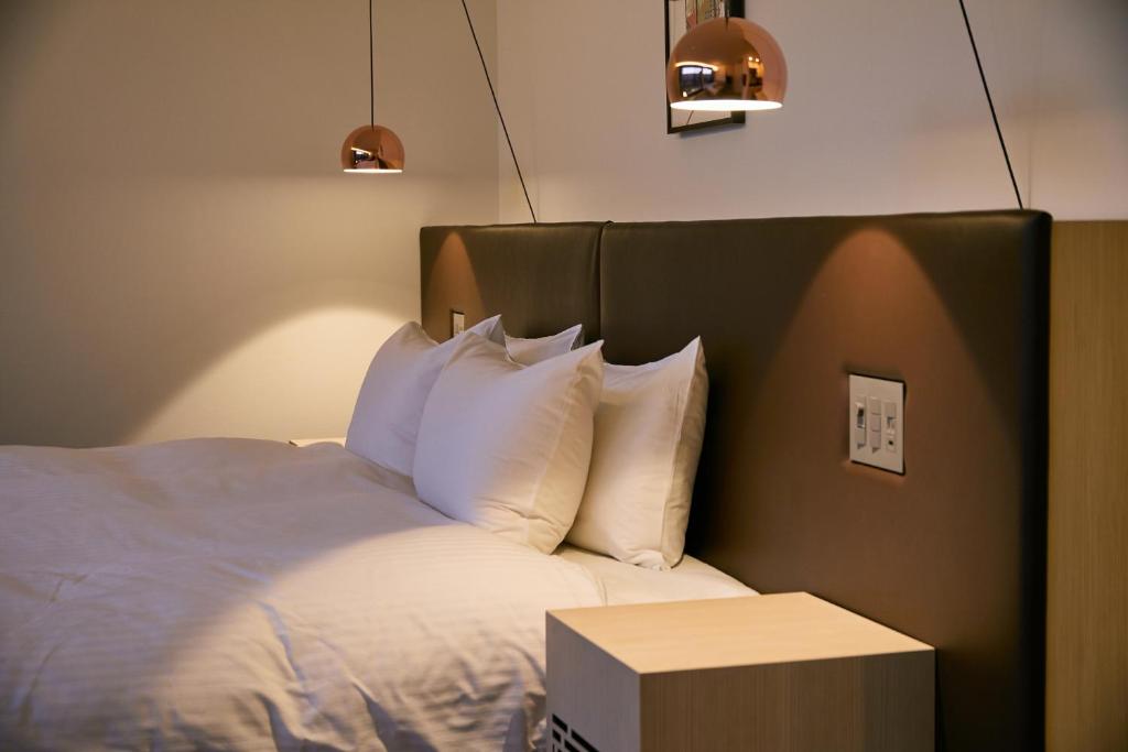 Postel nebo postele na pokoji v ubytování HOTEL KYOTOLOGY