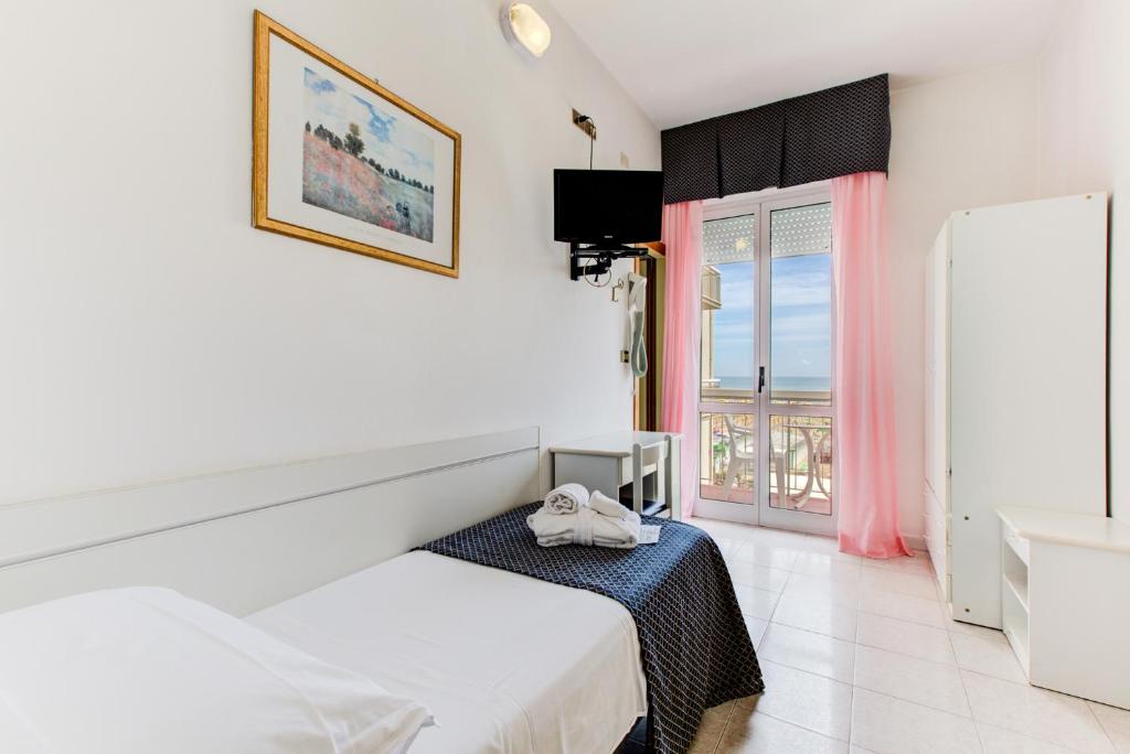 Postel nebo postele na pokoji v ubytování Hotel Vela d'Oro