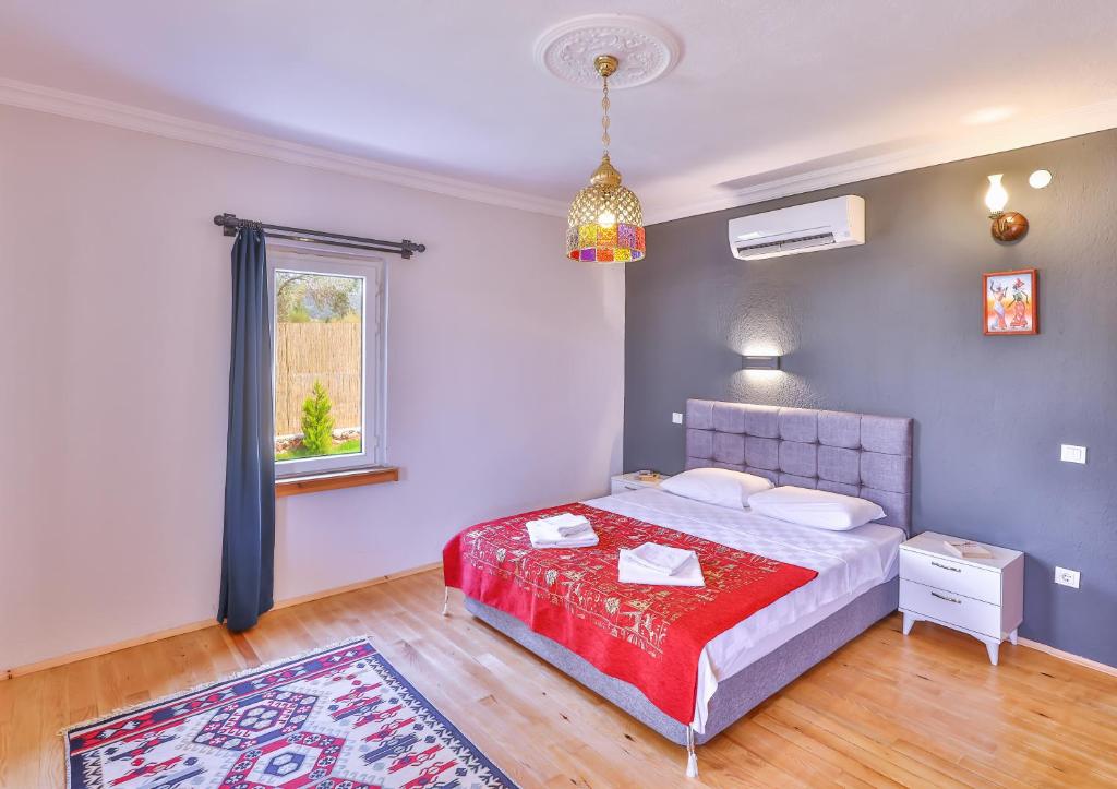 a bedroom with a bed and a window and a rug at Villa Grando 2 in Kas