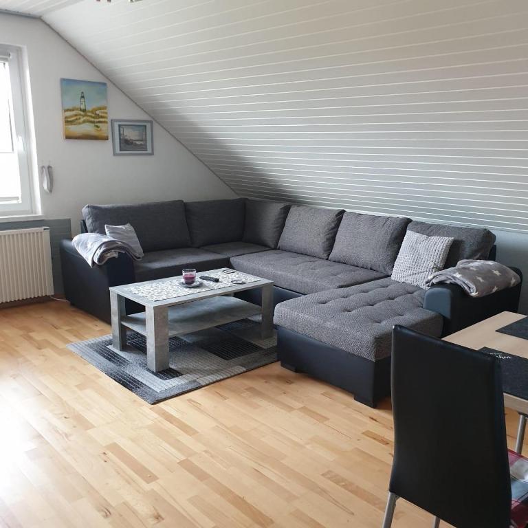 a living room with a couch and a table at Ferienwohnung Schäfer Deichgraf in Burhave