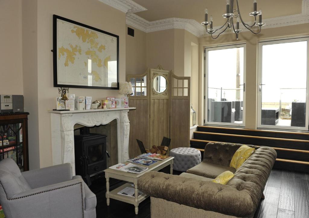 a living room with a couch and a fireplace at Suenos Guesthouse in Southend-on-Sea