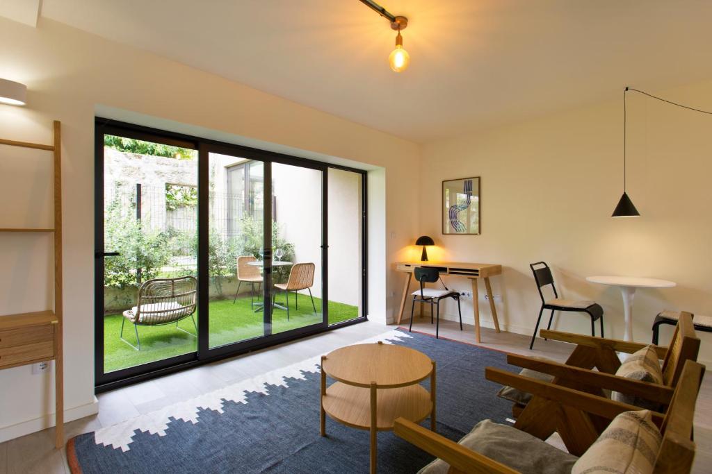 ein Wohnzimmer mit einem Sofa und einem Tisch in der Unterkunft Zen Garden Studio D in Porto