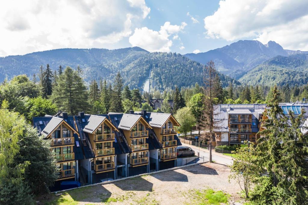 an aerial view of a resort with mountains in the background at TatryTop Apartamenty Sabała in Zakopane