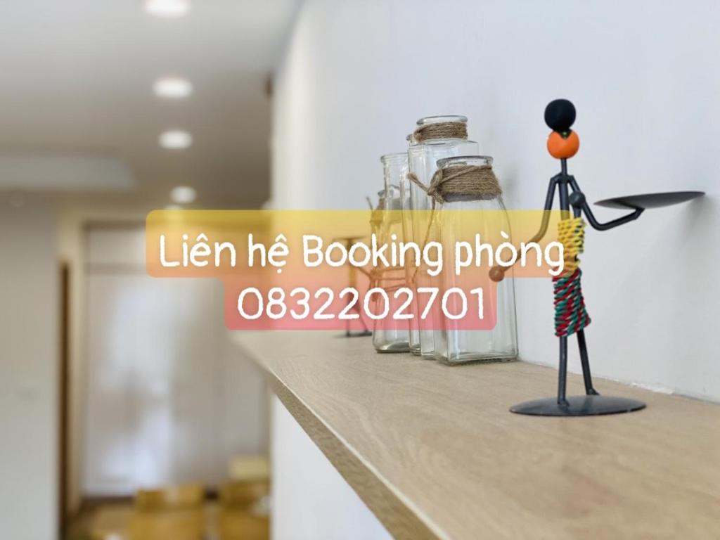 a figurine standing on a counter next to glass jars at TMS Pullman Căn Hộ Cao Cấp Quy Nhơn in Quy Nhon