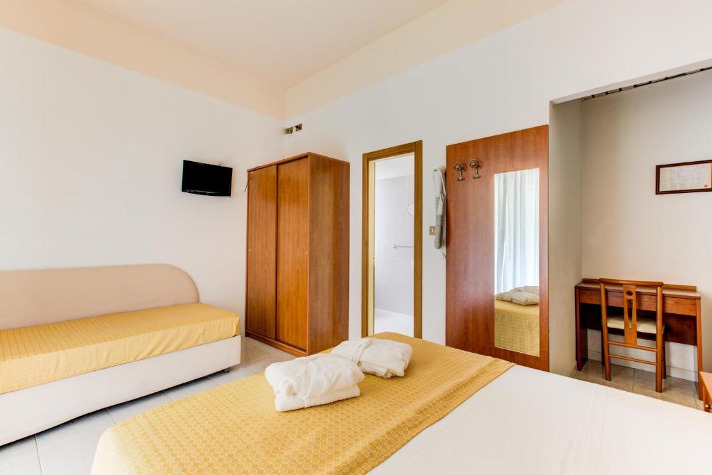 Postel nebo postele na pokoji v ubytování Hotel Vela d'Oro