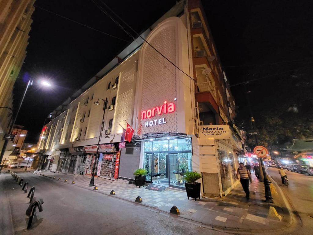 a building with a sign on the side of a street at MALATYA NORVIA HOTEL in Malatya
