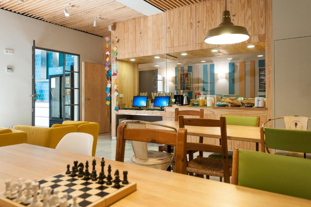 a room with a chess board on a table at The Nomad Hostel&Pension in Seville