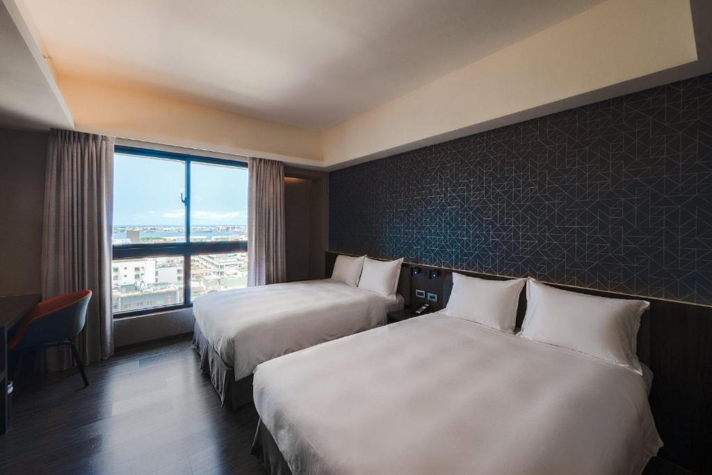 Postel nebo postele na pokoji v ubytování Holiday Inn Express Kaohsiung Love River by IHG