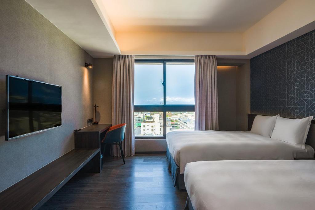 Postel nebo postele na pokoji v ubytování Holiday Inn Express Kaohsiung Love River by IHG