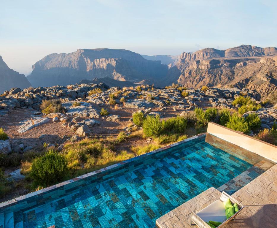 a swimming pool with a view of the mountains at Anantara Al Jabal Al Akhdar Resort in Al ‘Aqar
