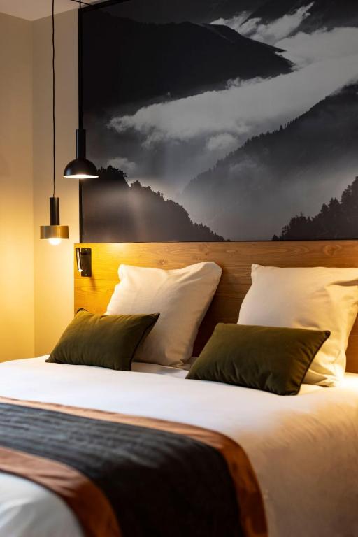 a bedroom with two beds and a painting of clouds at HIGALIK HOTEL in Les Menuires