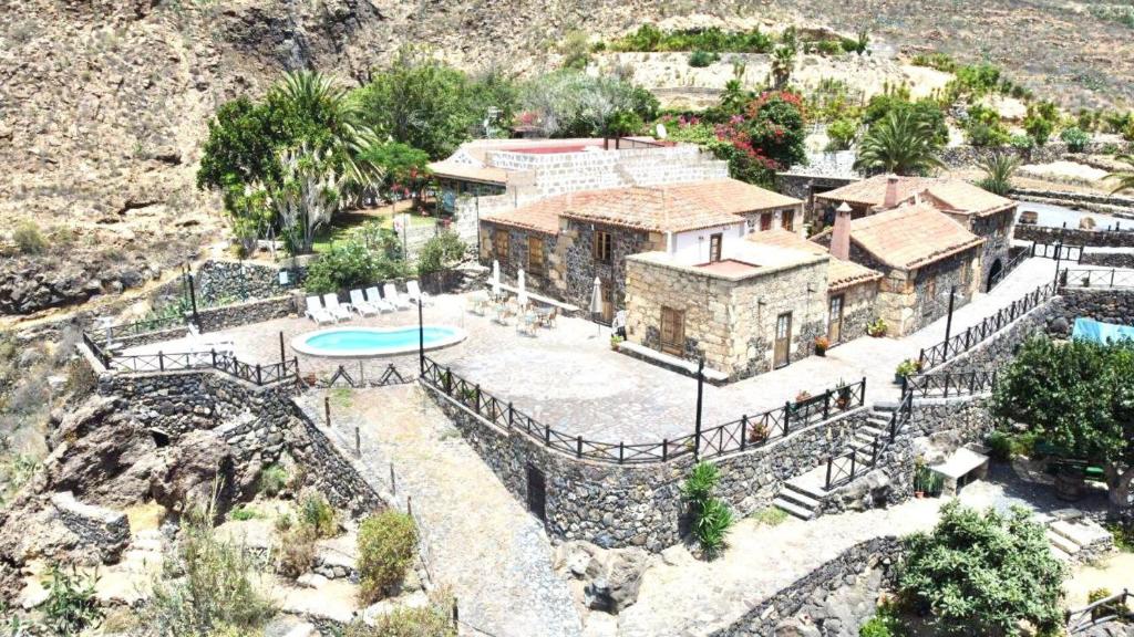 an aerial view of a house with a pool at Caserio rural antiguo con espectacular piscina y Wifi en San Miguel de Abona, Tenerife Sur in San Miguel de Abona