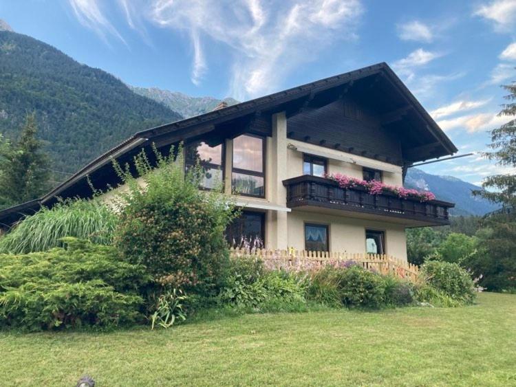 a house with a balcony with flowers on it at FeWo Berk in Kühnburg