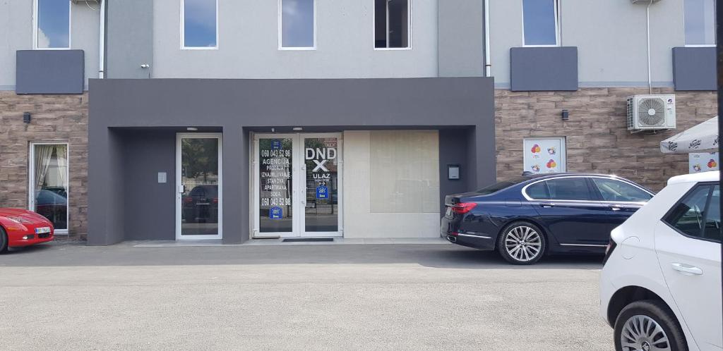 a blue car parked in front of a building at DND-X in Pančevo