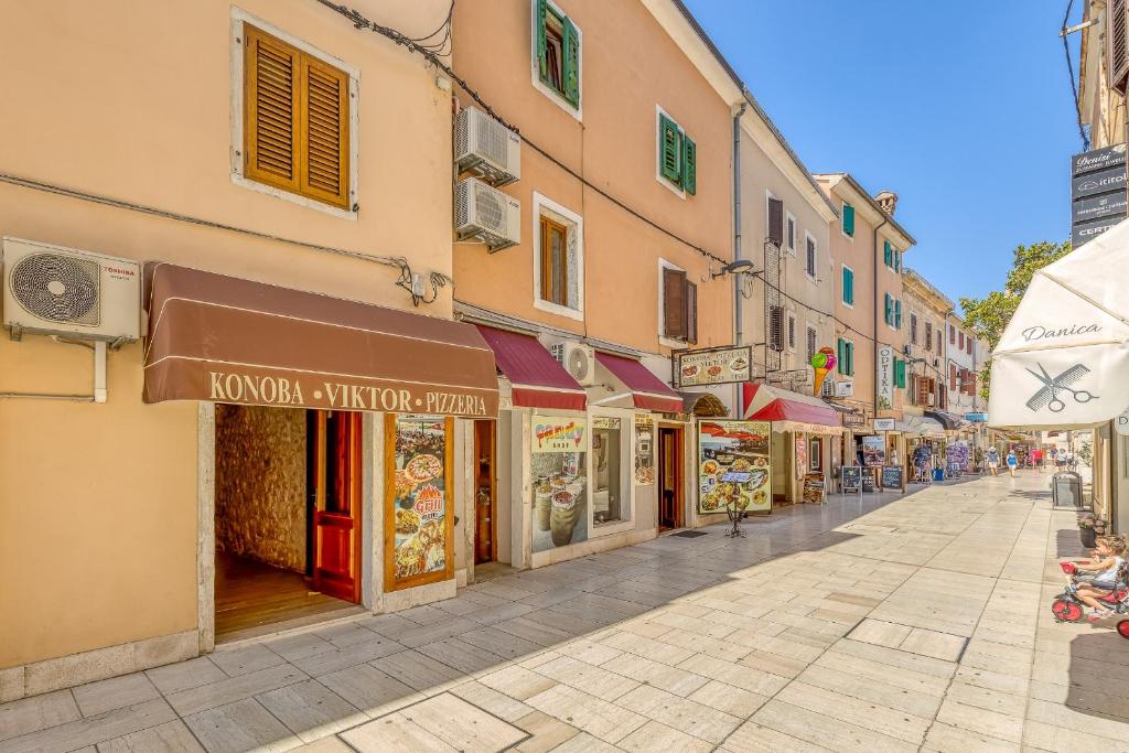 a street with shops and buildings in a city at Casa Viktor in Umag