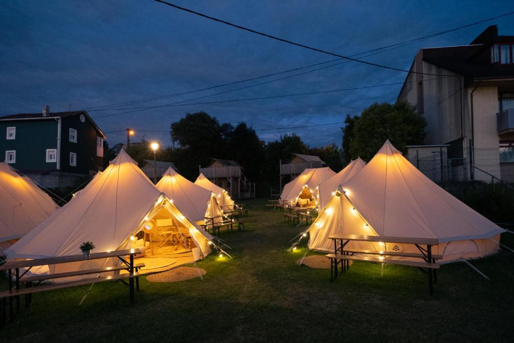 a group of tents in a field at night at Kampaoh Castrillón in Naveces