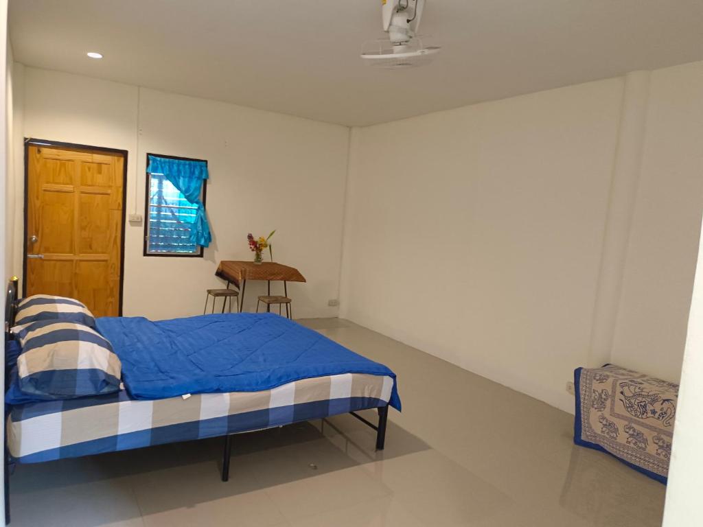 a bedroom with a bed and a table in it at sunny in town in Pai