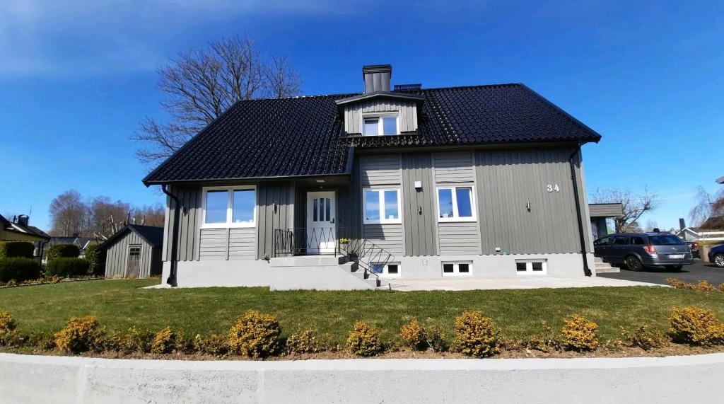 uma casa cinzenta com um telhado preto em Apartments in Smålandsstenar em Smålandsstenar