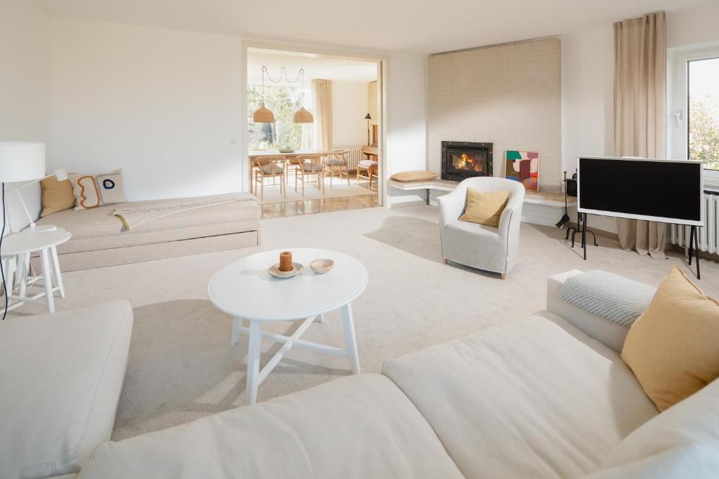 a living room with a couch and a table at Haus Janus 1 - Wohnung 1 in Norderney