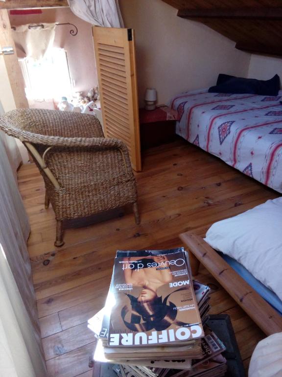 a bedroom with a bed and a magazine on a table at Comfortable Quiet House in the countryside Porte-du-Quercy for 8 people in Sérignac