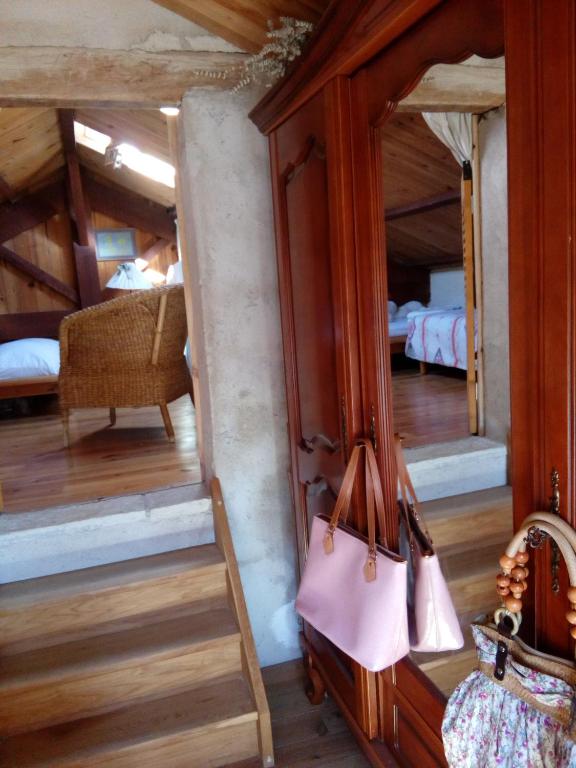 an attic room with a mirror and a bedroom at Comfortable Quiet House in the countryside Porte-du-Quercy for 8 people in Sérignac