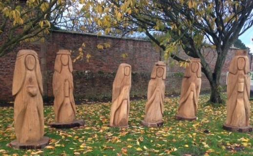 a group ofulptures of people dressed in robe at Pintail Apartment Bamburgh in Bamburgh