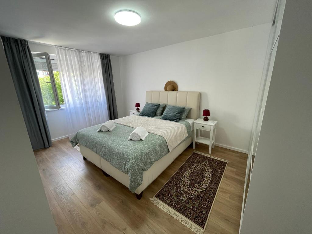 a bedroom with a large bed with a green blanket at Amigi in Sarajevo