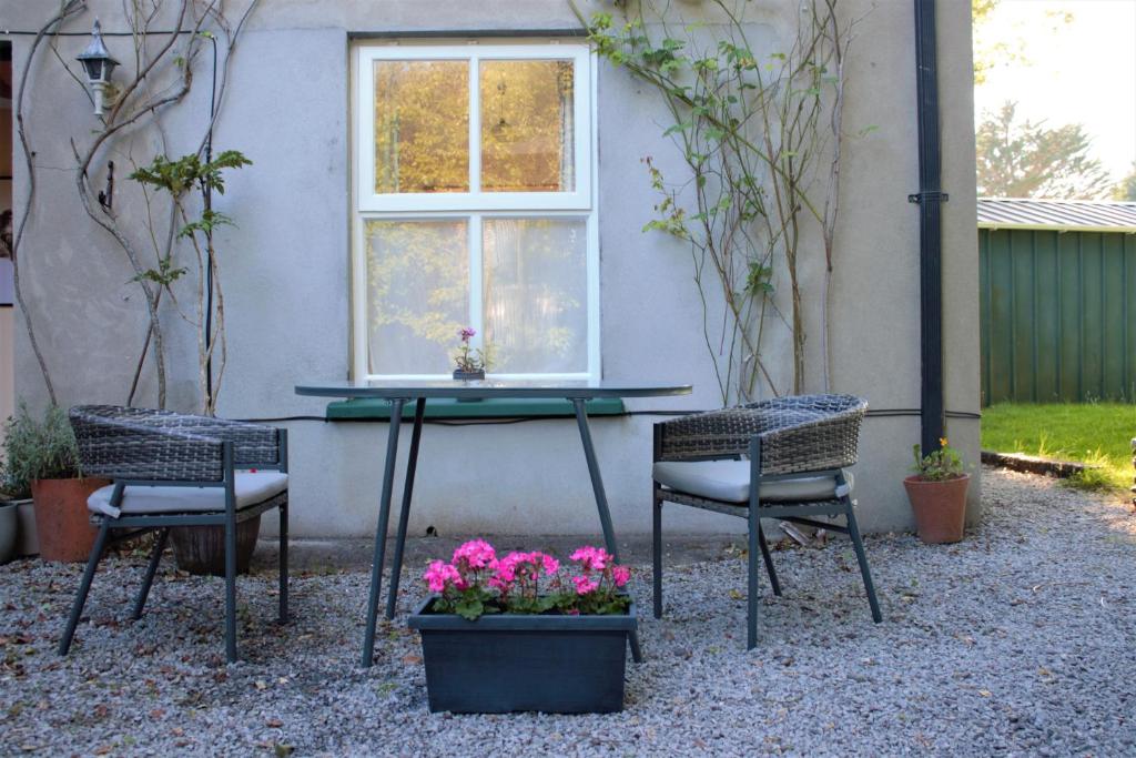 a table and two chairs and a window at Remarkable Apartment in Kenmare Ireland in Kenmare