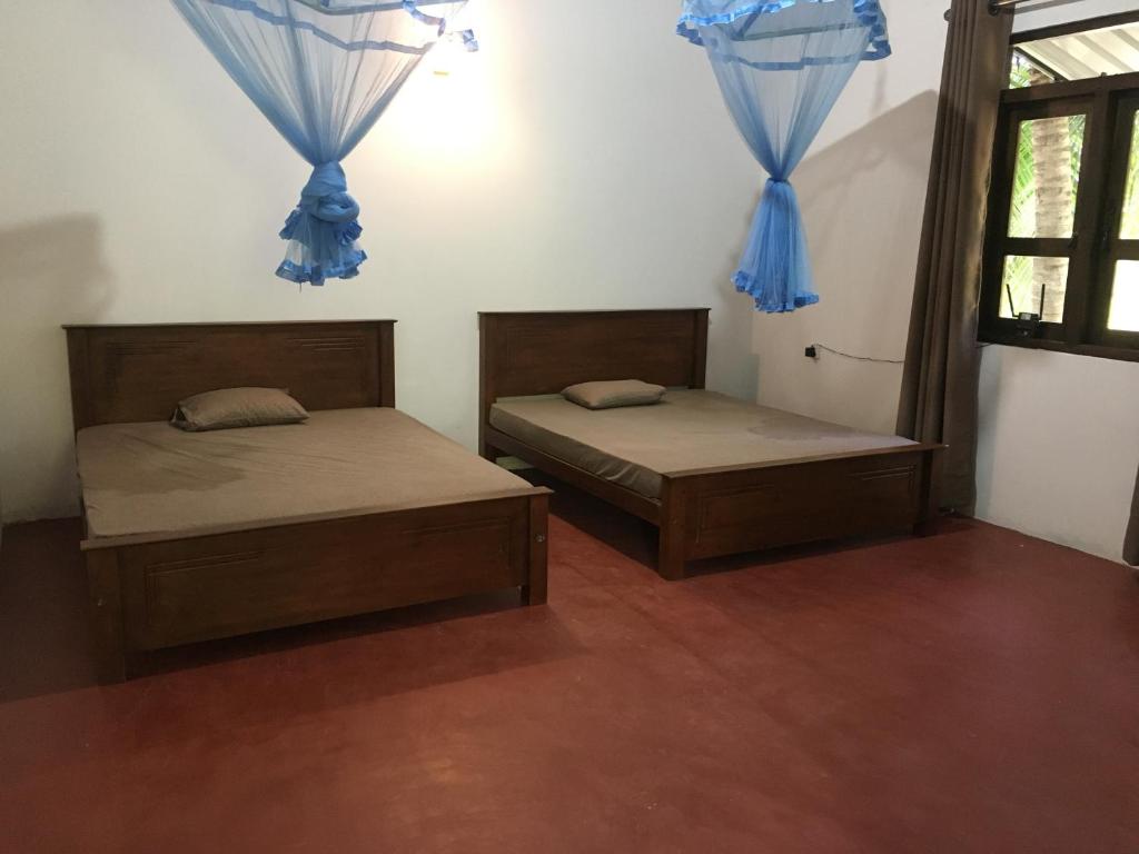 Postel nebo postele na pokoji v ubytování Yuthara - Anuradhapura