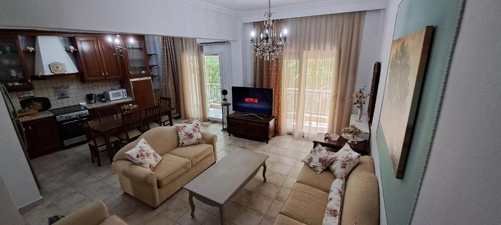 a living room with two couches and a tv at Angels' House in Thessaloniki