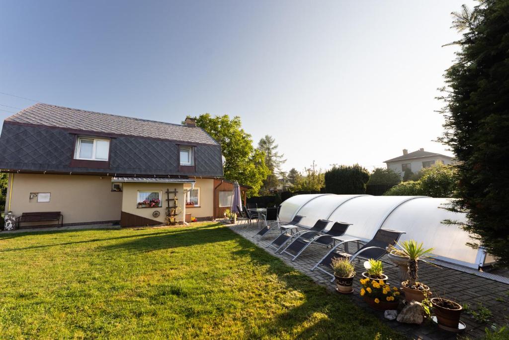 a row of domes in a yard next to a house at Penzion Mona in Jeseník