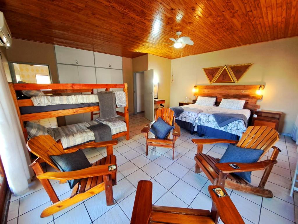 a room with two bunk beds and rocking chairs at Fish eagle Guest Farm in Phalaborwa