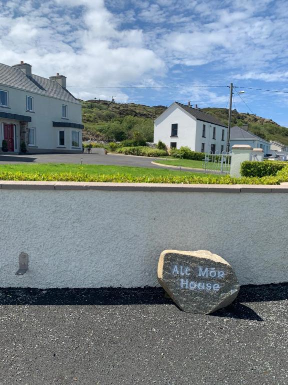 a rock sitting on the side of a curb at Alt Mór House Garden Studio-Self Catering Sleeps 2 in Portnoo