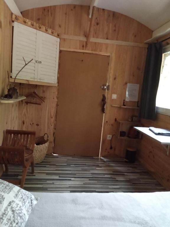 a room with a door into a room with wooden walls at Echappée sauvage in Masquières