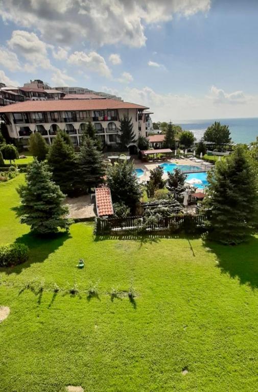 a view of a resort with a green lawn and a pool at Complex Monastery 1 -Marina Dinevi -Saint Vlas in Sveti Vlas