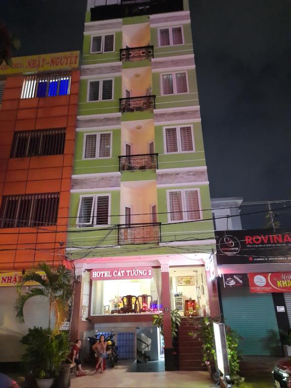 a tall building with a store in front of it at Cát tường 2 hotel in Ho Chi Minh City