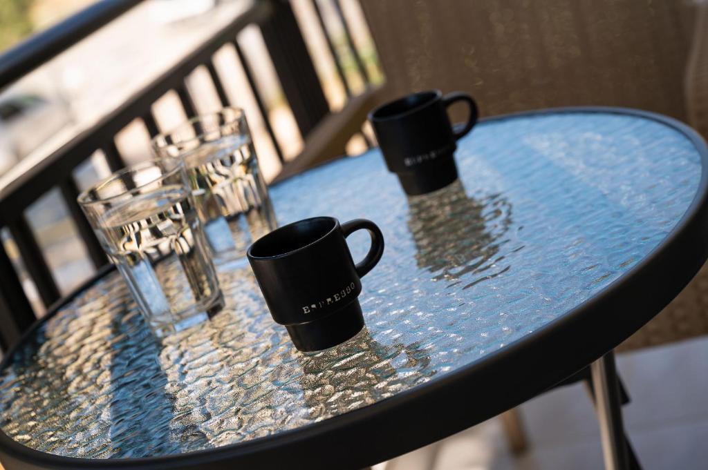 a table with two cups and glasses on it at Amalia in Matala